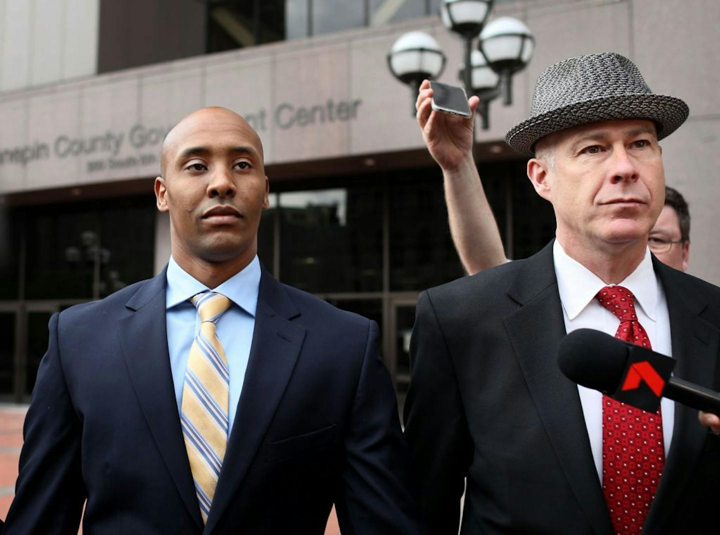 Former Minneapolis police officer Mohamed Noor, left, appeared in Hennepin County District Court with his attorney, Thomas Plunkett but left court wit
