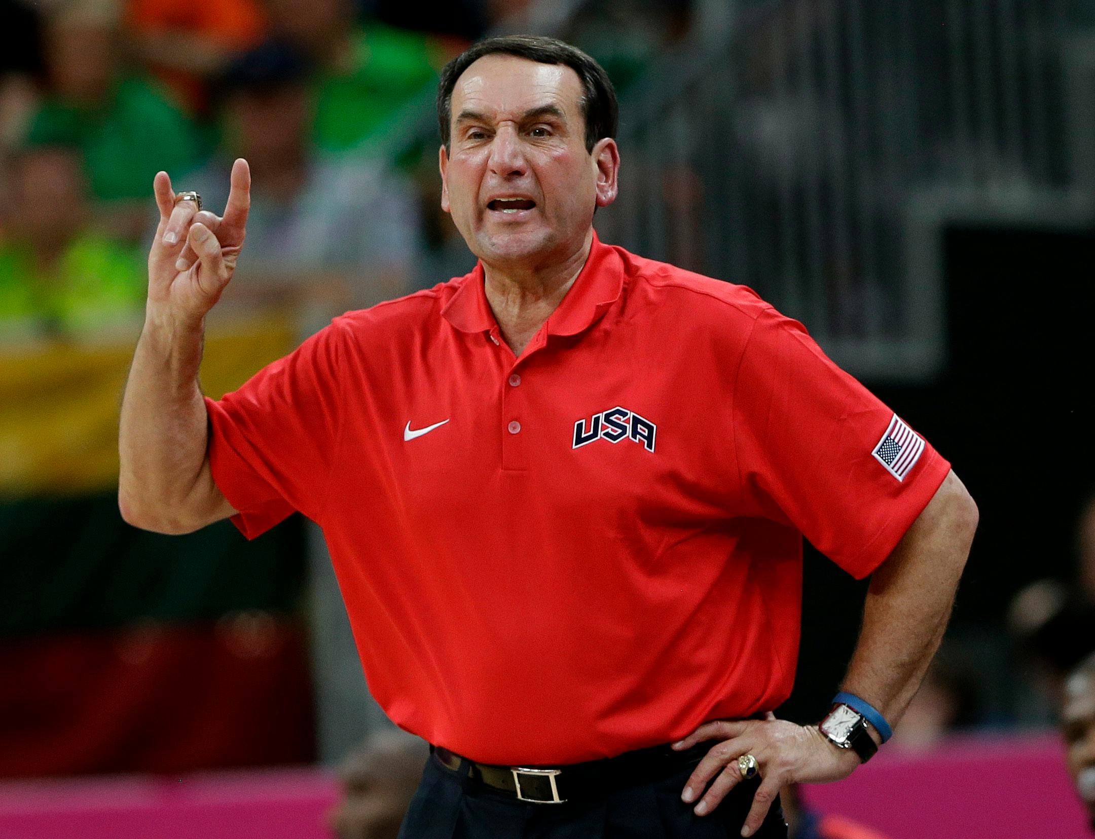 In this Aug. 4, 2012, file photo, United States coach Mike Krzyzewski signaled to players during a preliminary men's basketball game against Lithuania at the 2012 Summer Olympics in London. A person with knowledge of the decision says Krzyzewski has agreed to return as U.S. men's Olympic basketball coach. He was originally expected to step down but instead will attempt to lead the Americans to a third straight gold medal.