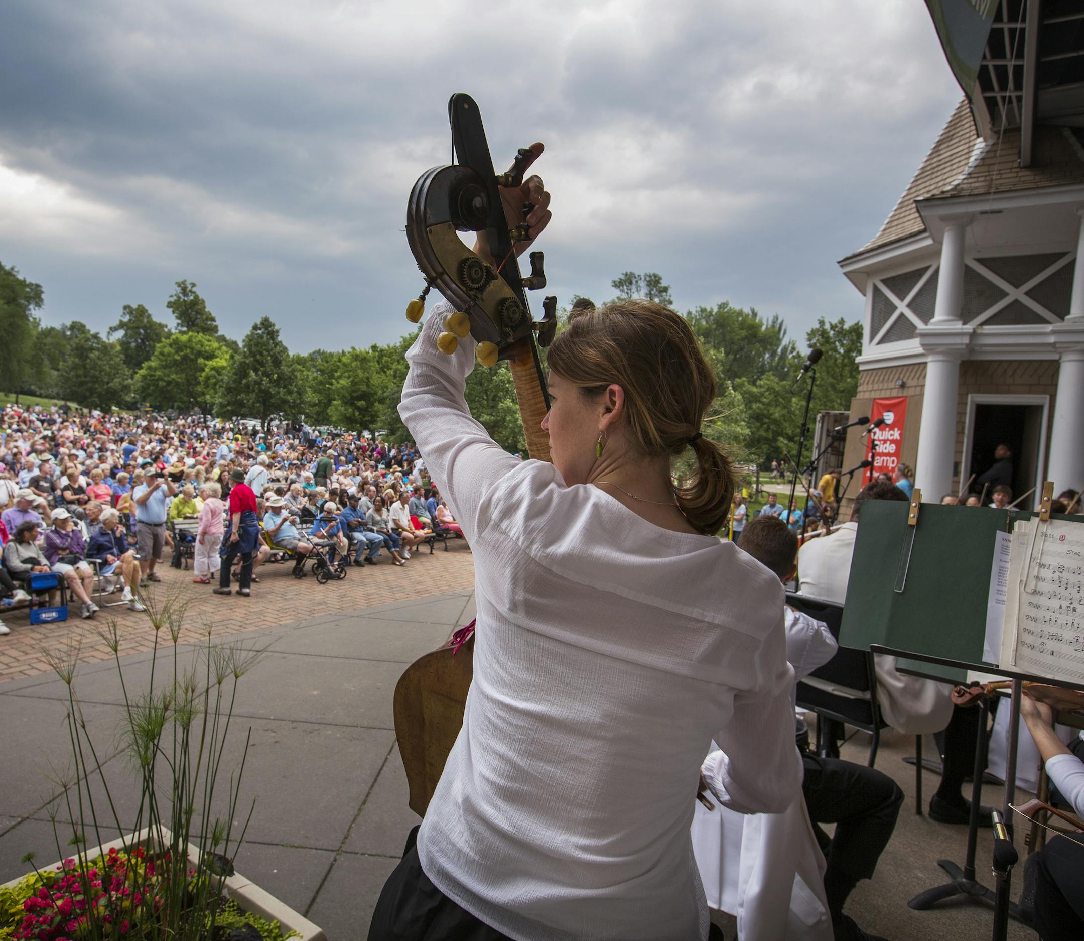 Bassist Kathryn Nettleman warms up before the Minnesota Orchestra's Symphony for the Cities performance at the Lake Harriet Bandshell in Minneapolis on Monday, June 29, 2015. ] LEILA NAVIDI leila.navidi@startribune.com / BACKGROUND INFORMATION: Every year the Minnesota Orchestra presents a series of free outdoor concerts called Symphony for the Cities. Other Symphony for the Cities performances: -Wednesday, July 1 at the Hilde Performance Center in Plymouth -Thursday, July 2 at the Winona Lake P