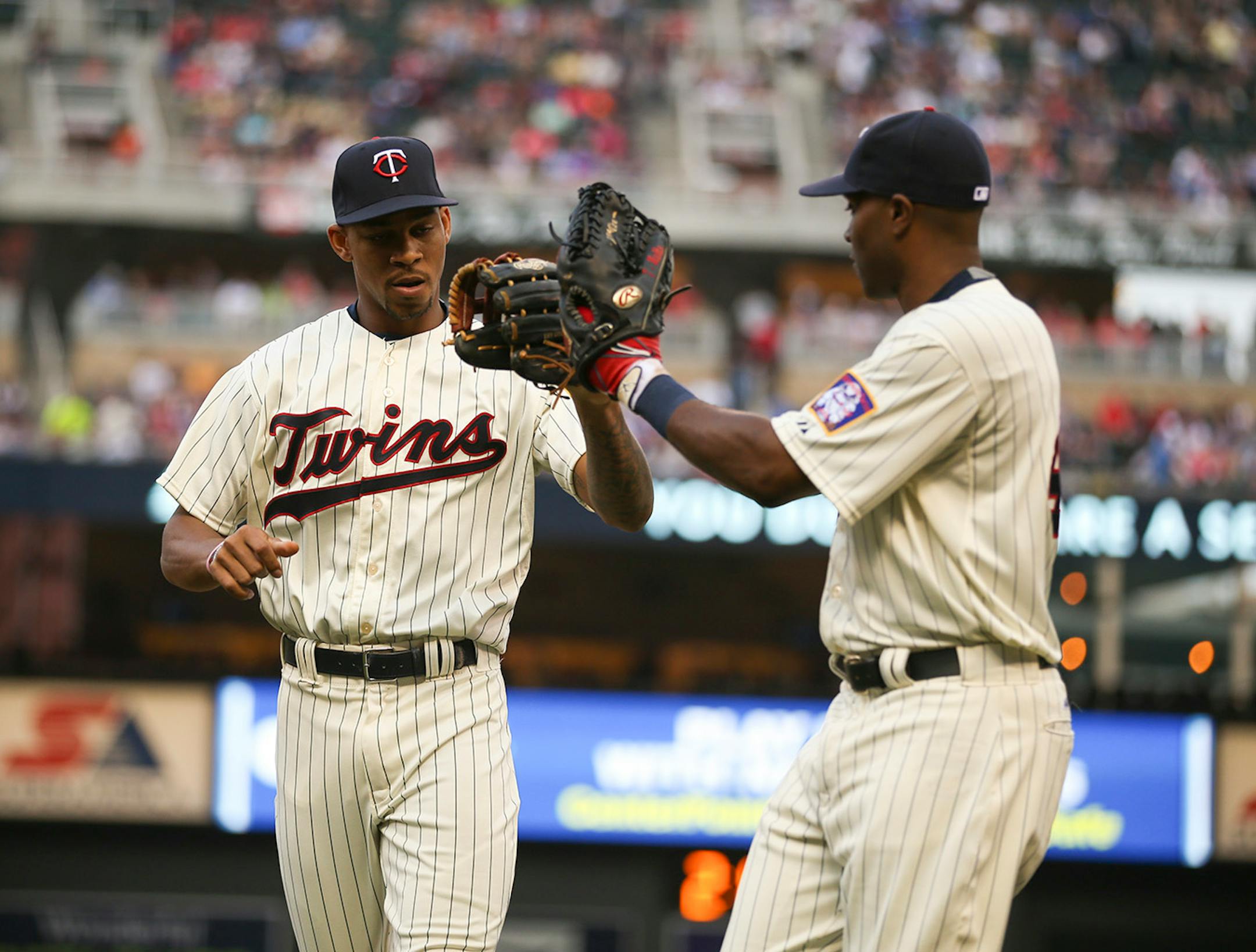 Minnesota Twins center fielder Byron Buxton (25) was congratulated by Minnesota Twins right fielder Torii Hunter (48) as they came off the field after a nice catch in the third inning Wednesday evening.
