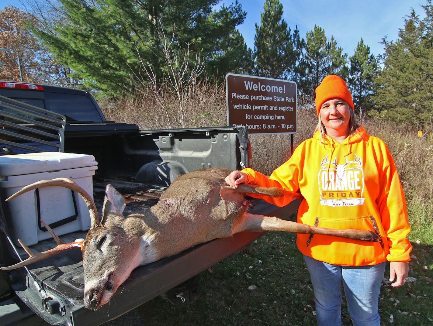 Vicki Britt of New Richland, Minn., with a six-point buck she shot Saturday morning at the special hunt inside William O'Brien State Park. Photo by Tony Kennedy