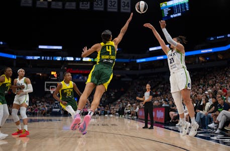 Lynx guard Kayla McBride (21) puts up a three-pointer over the outstretched arm of Storm guard Skylar Diggins-Smith during the second half Sunday nigh