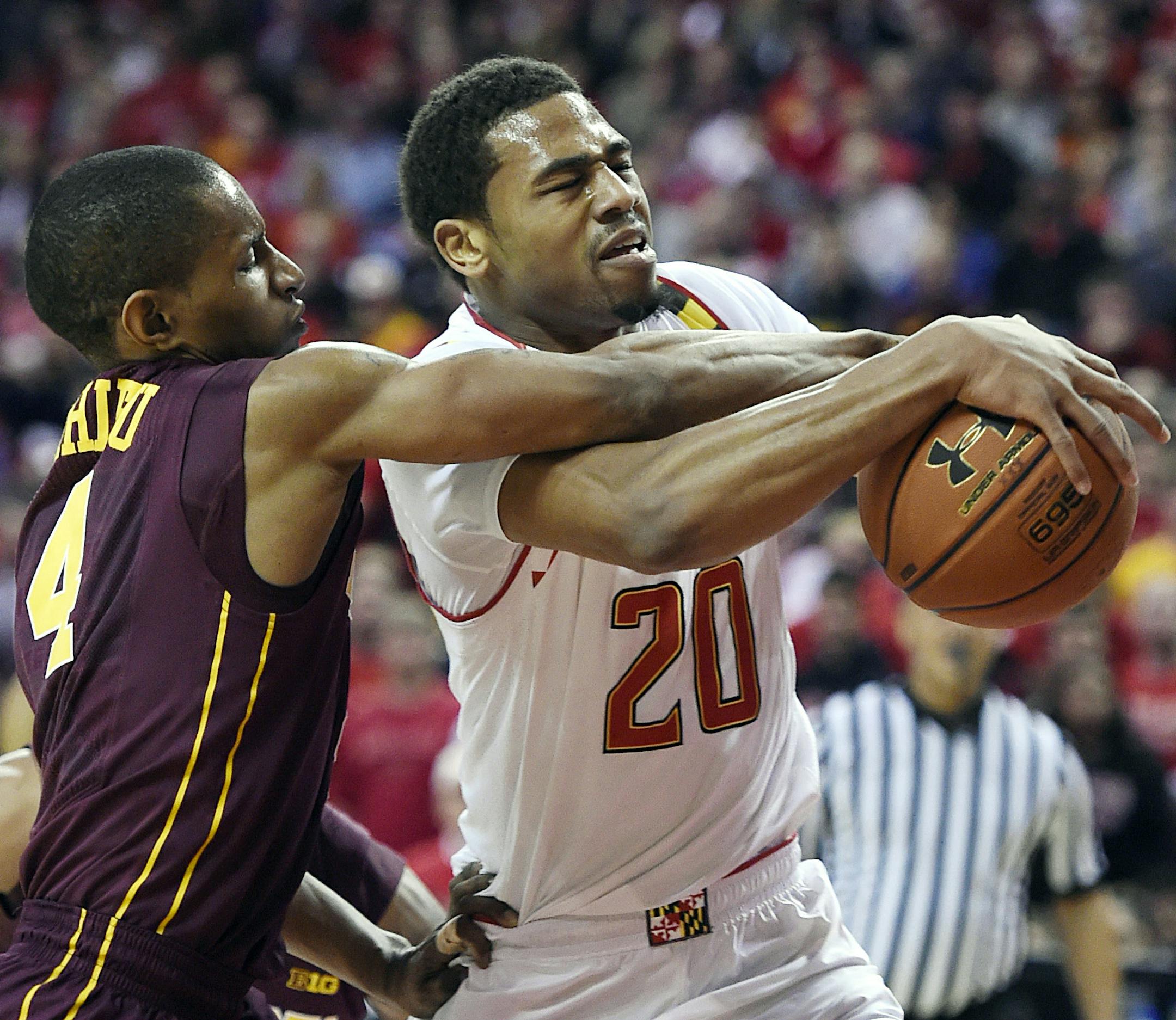 Maryland guard Richaud Pack, right, drives to the basket as Minnesota guard Deandre Mathieu defends during the first half of an NCAA college basketball game, Saturday, Jan. 3, 2015, in College Park, Md. (AP Photo/Gail Burton)