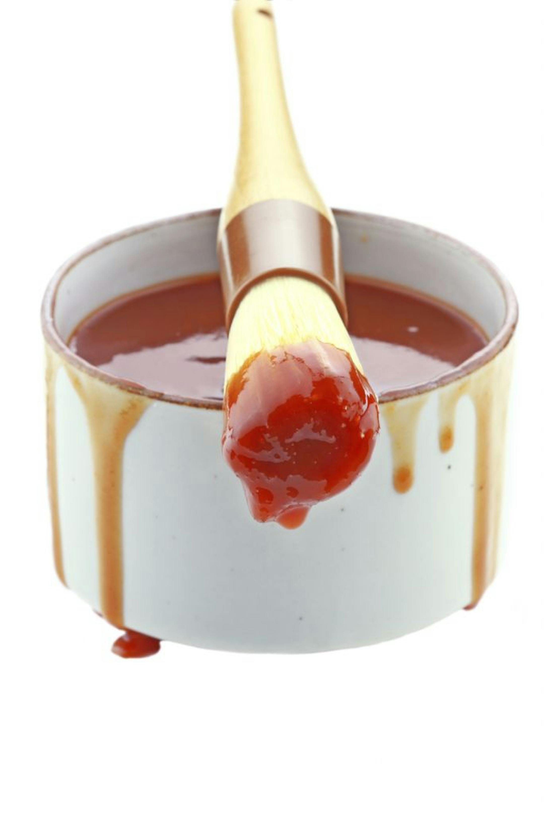 Stephanie Frey � istockphoto.comBarbecue sauce and basting brush isolated on white.