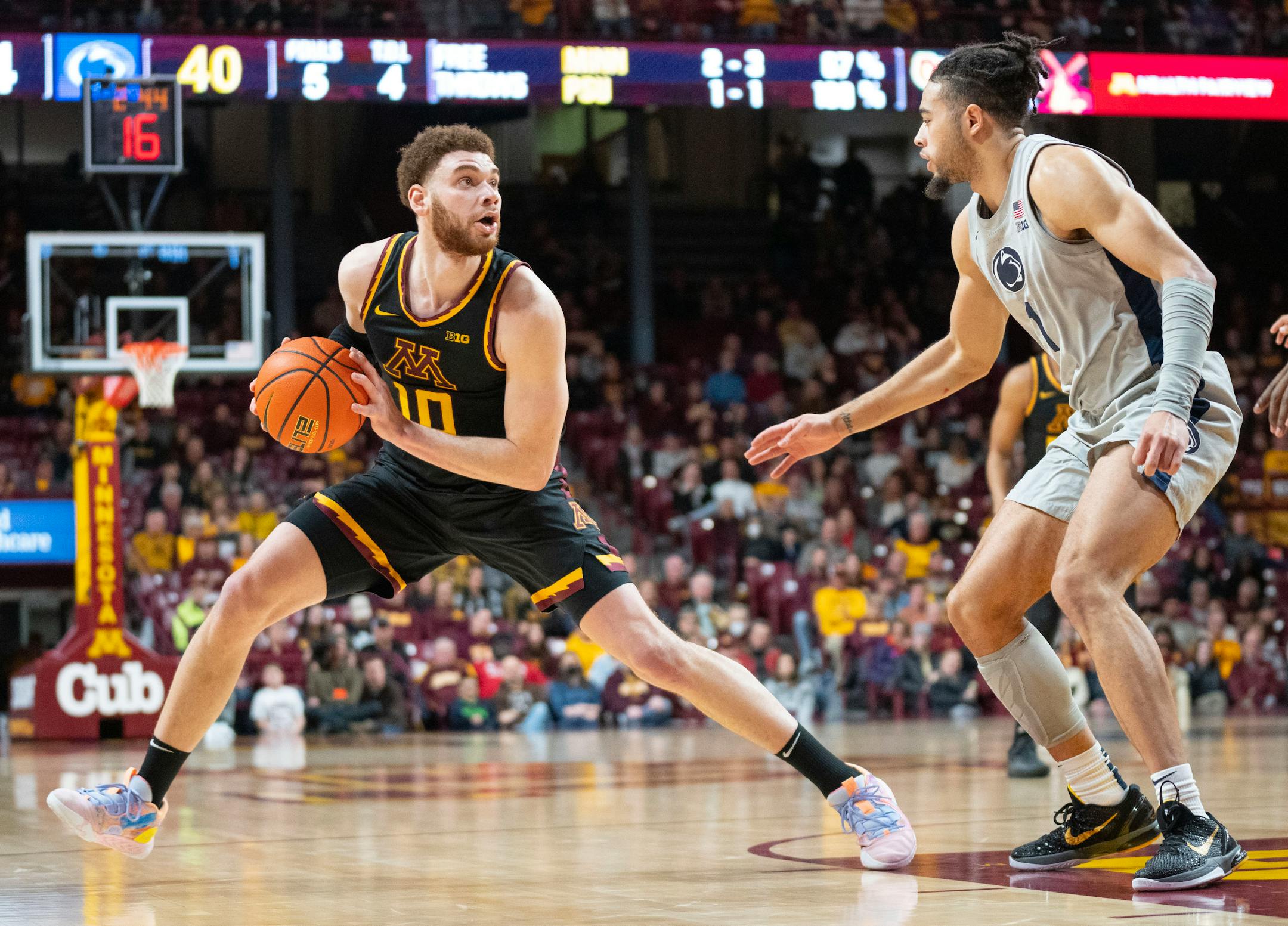 Minnesota forward Jamison Battle (10) steps back to take a shot in front of Penn State guard Seth Lundy (1) in the first half.