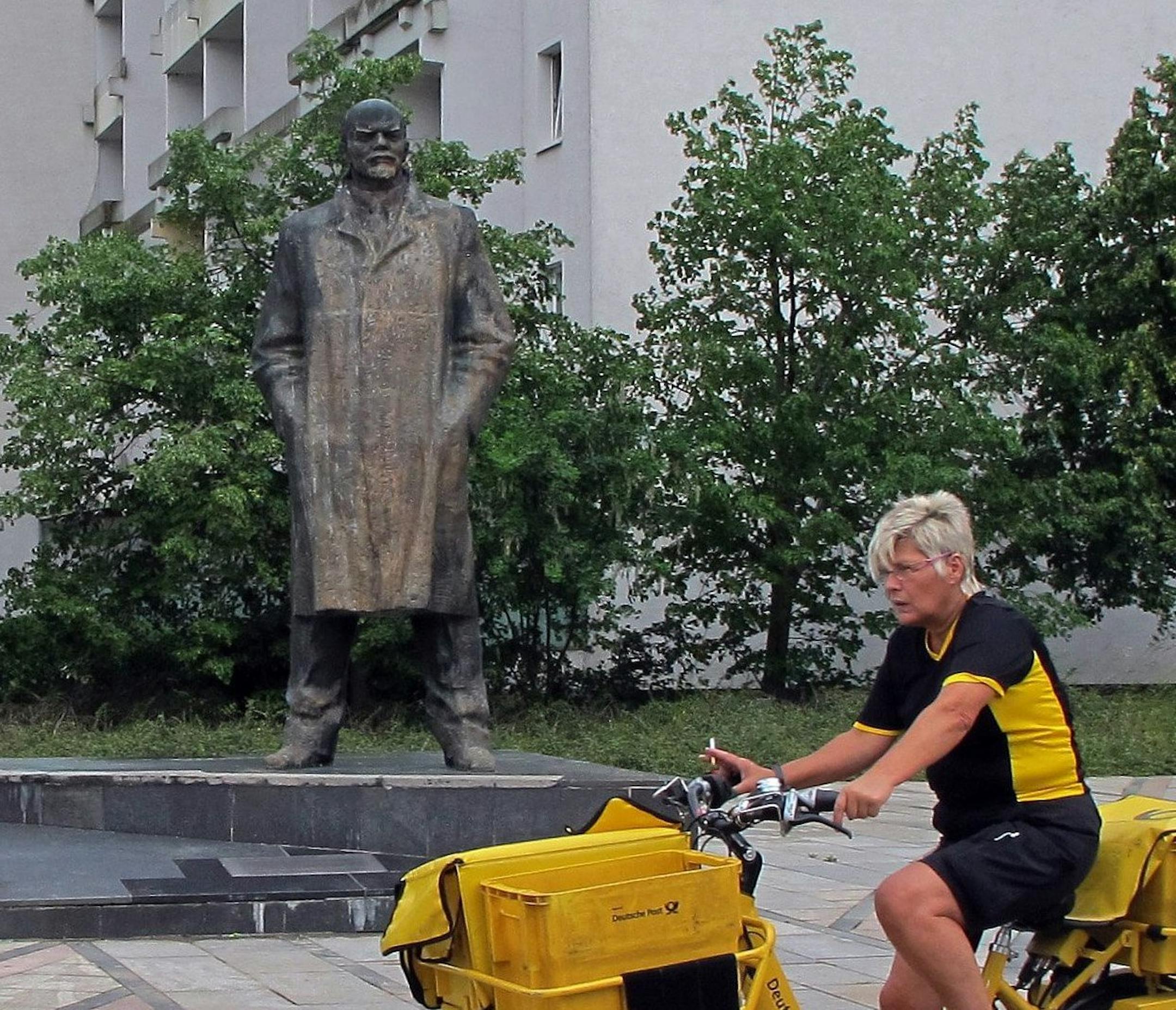 The Schwerin, Germany, Lenin statue, seen June 13, 2014, erected in 1985, as a German postal worker rides by. Some residents want the statue torn down, while others believe it's important to keep it standing. (Claudia Himmelreich/MCT)