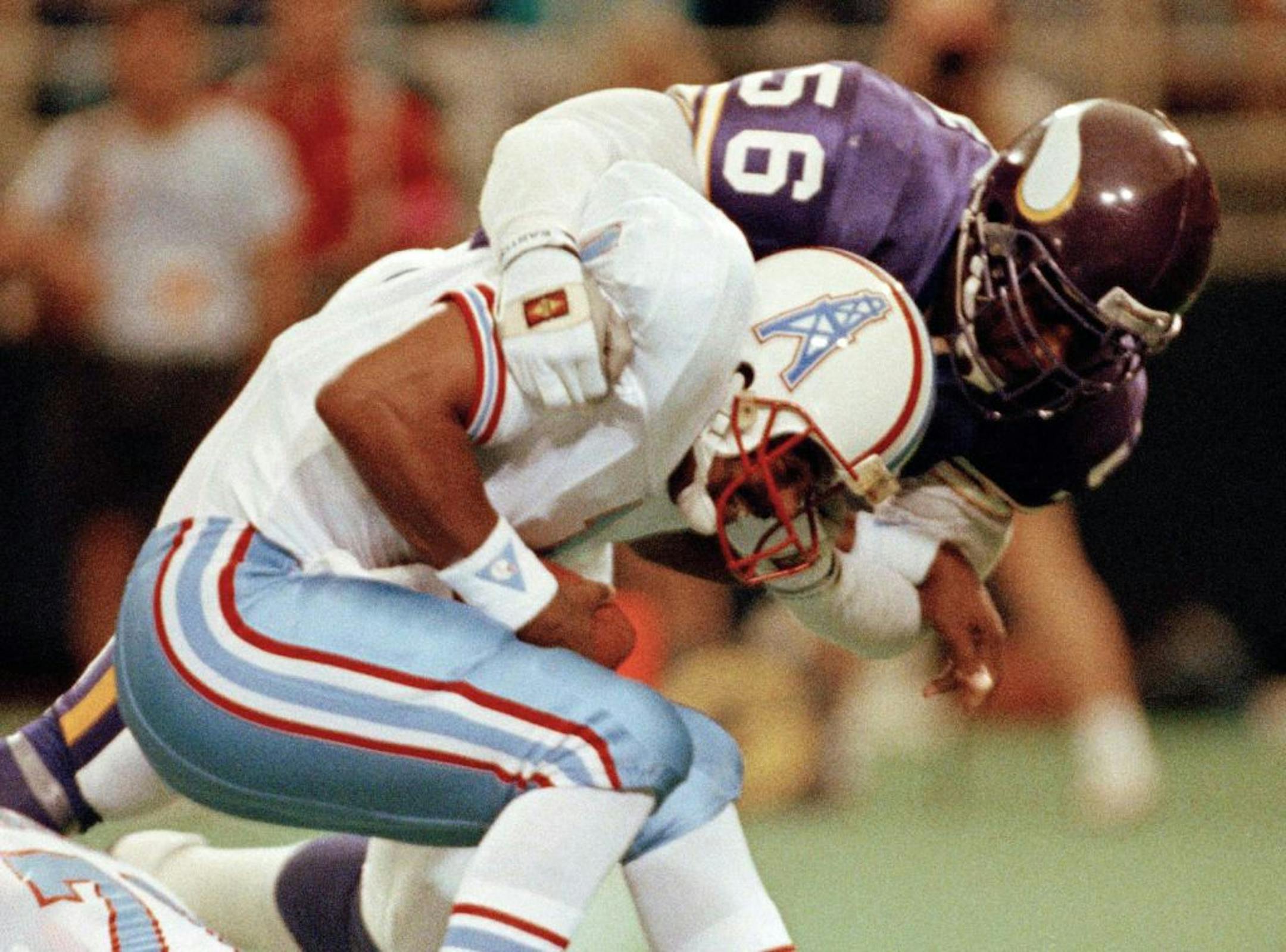 FILE - In this Aug. 27, 1990, file photo, Minnesota Vikings linebacker Chris Doleman (56) brings down Houston Oilers quarterback Warren Moon for a safety during preseason NFL football action in Minneapolis. Doleman was elected to the Pro Football Hall of Fame on Saturday, Feb. 4, 2012.