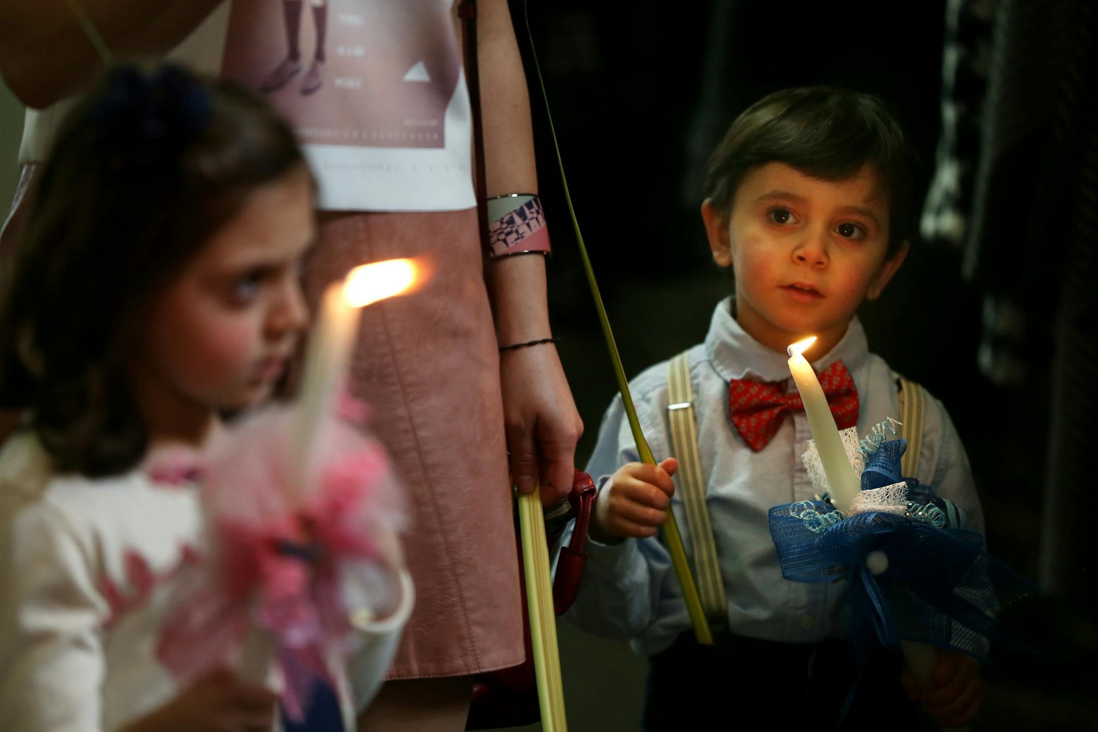 Ema Khouri 6, and her brother Anthony Khouri 3, held candles after Palm Sunday at Maron's Catholic Church March 20, 2016 in Minneapolis, MN.