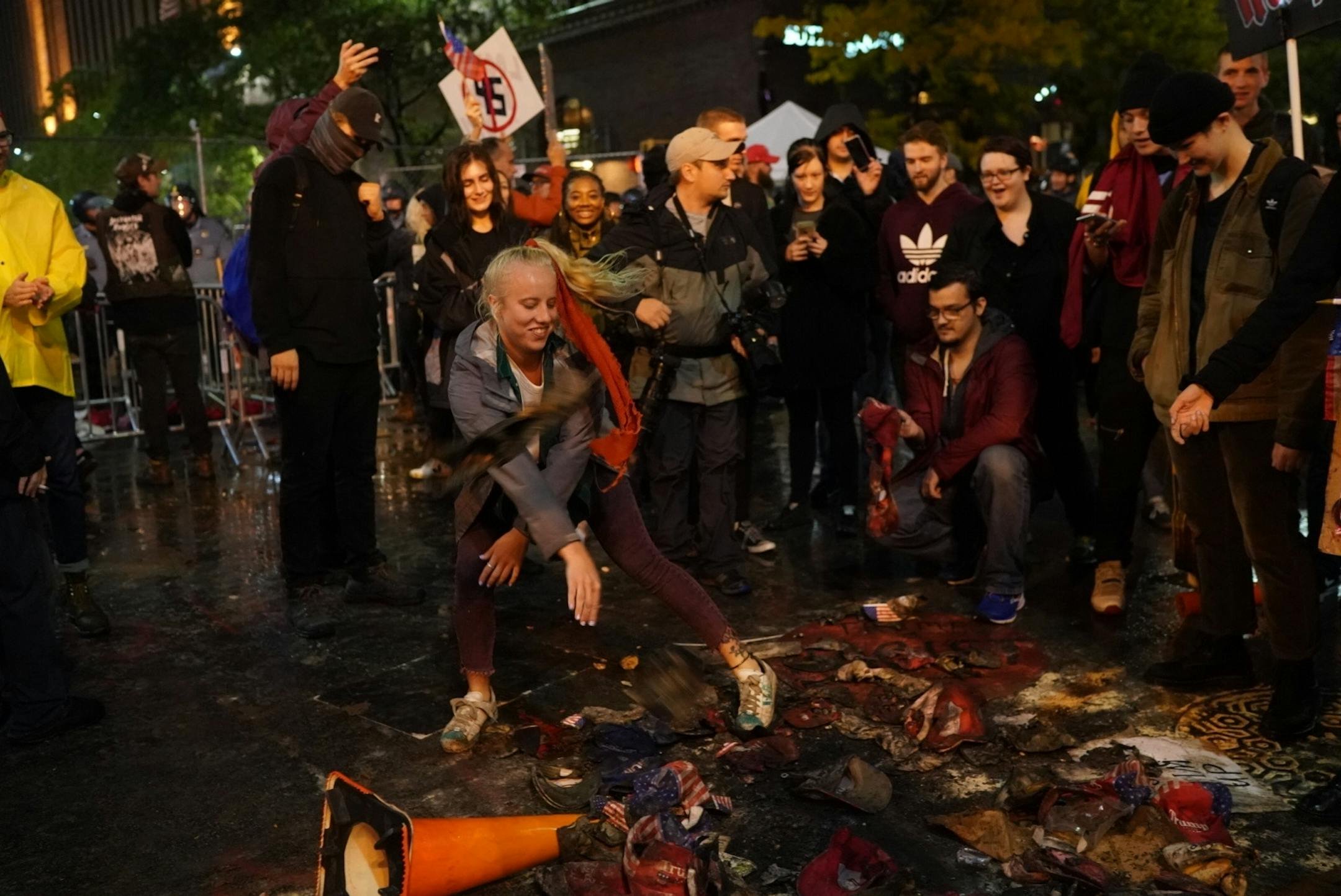 Tyana Loiselle of St. Paul danced in a pile of burnt Trump hats outside the Target Center after President Donald Trump visited Minneapolis, Minn., for a campaign rally on October 10, 2019.