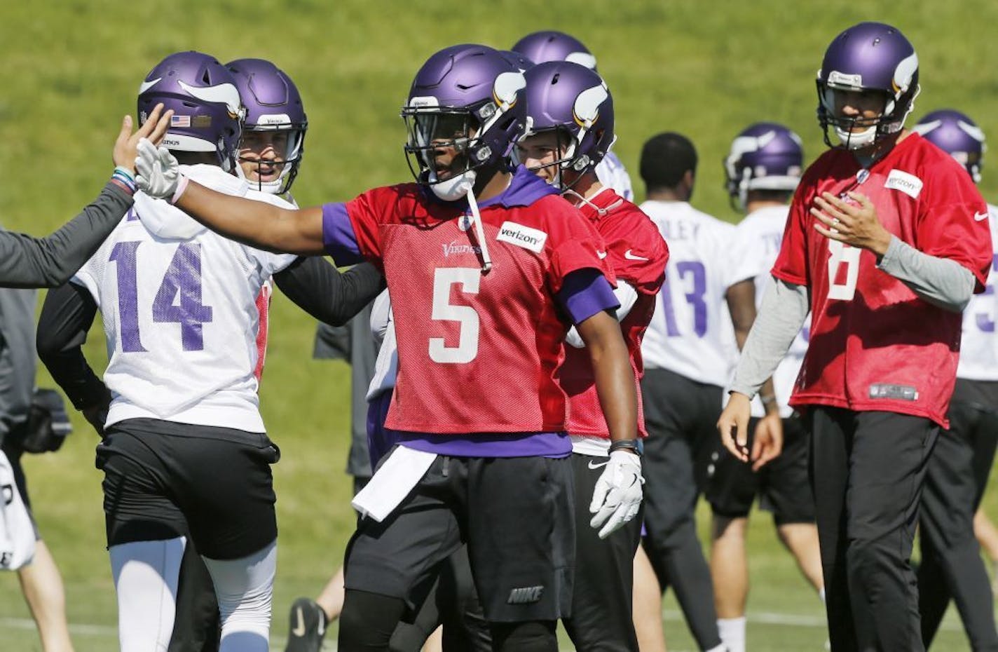 Minnesota Vikings quarterback Teddy Bridgewater (5) joins other quarterbacks including Sam Bradford, right, during the NFL football teams practice Tuesday, June 6, 2017, in Eden Prairie, Minn. Bridgewater is recovering from a knee injury that kept him out last season. Bradford was signed to replace him as starting quarterback.