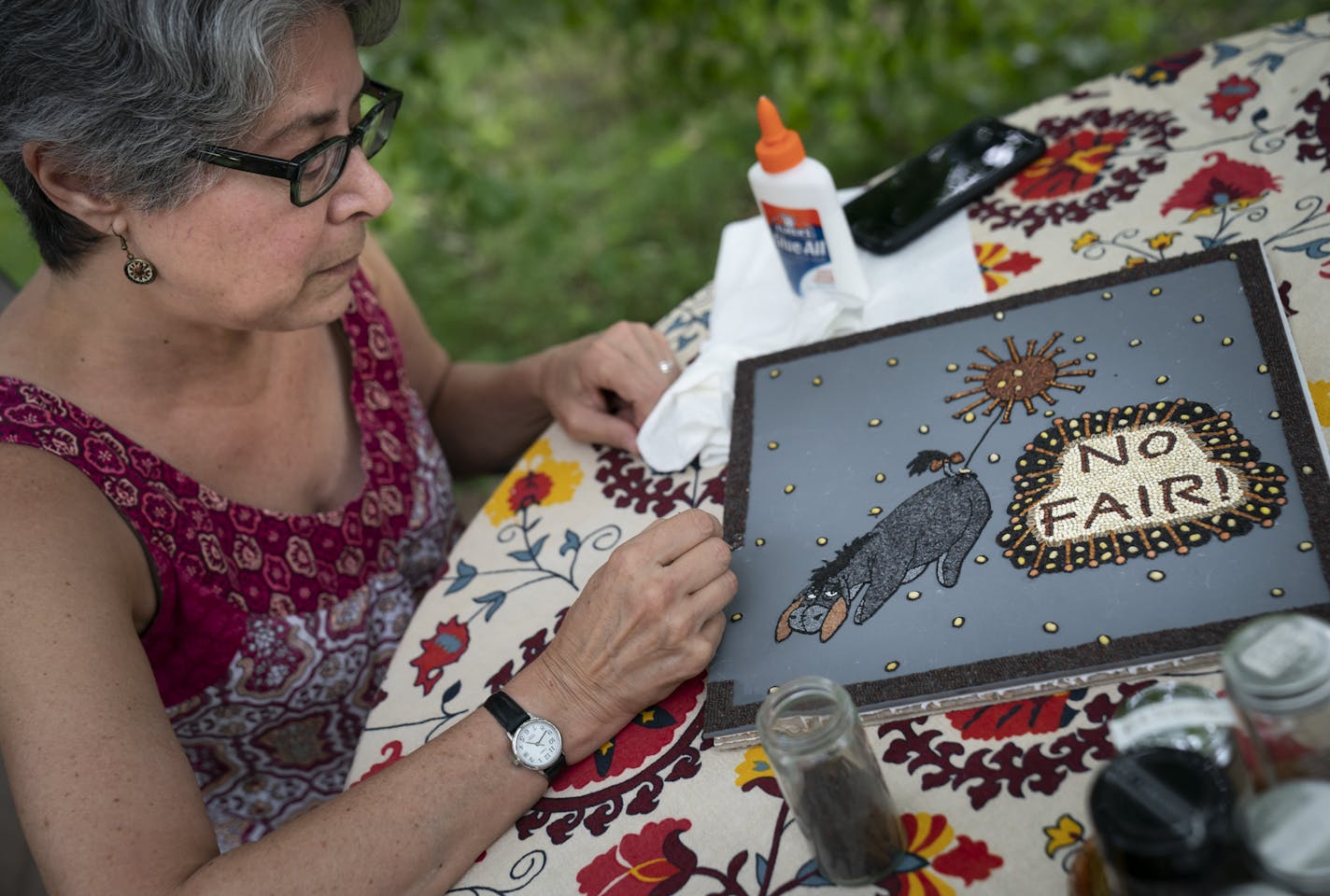 Seeds of creation: Crop artist Laura Melnick, top, worked on a piece for the State Fair's virtual showcase at her home in St. Paul. Melnick has won more than 30 ribbons since she began participating in the event in 1999, including eight Best in Show.