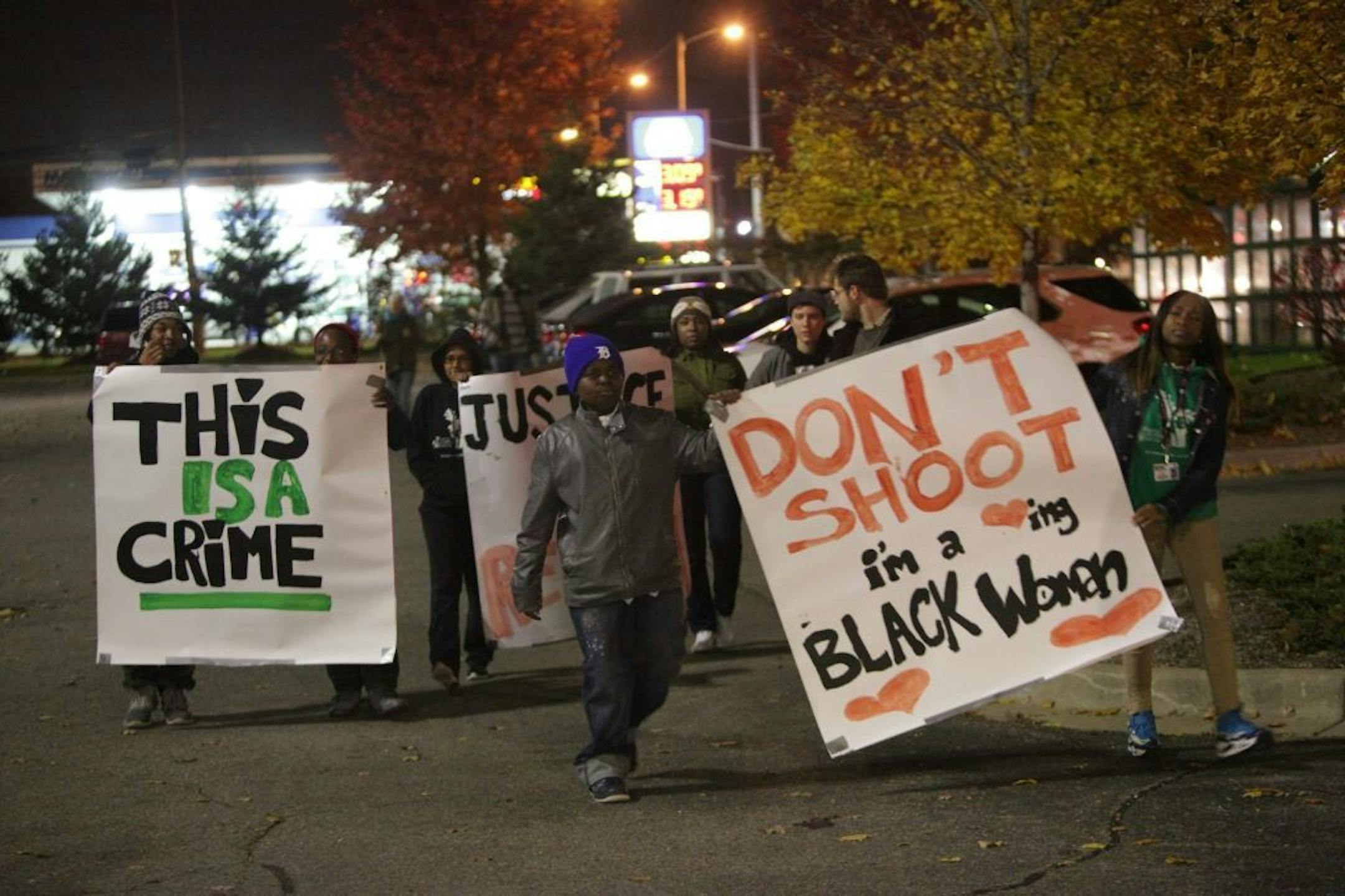 Protesters hold signs during a rally to protest the shooting death of Renisha McBride at the Dearborn Heights Justice Center on Thursday, Nov. 7, 2013.
