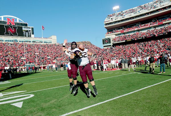 Minnesota's offensive lineman Tommy Olson (58), left, and Zac Epping (52) celebrated the Gophers 28-24 win over Nebraska at Memorial Stadium, Saturday