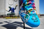 An NFL draft cleat is displayed near the Spirit of Detroit statue in Detroit, where the draft will be held beginning Thursday.
