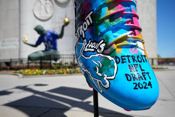 An NFL draft cleat is displayed near the Spirit of Detroit statue in Detroit, where the draft will be held beginning Thursday.
