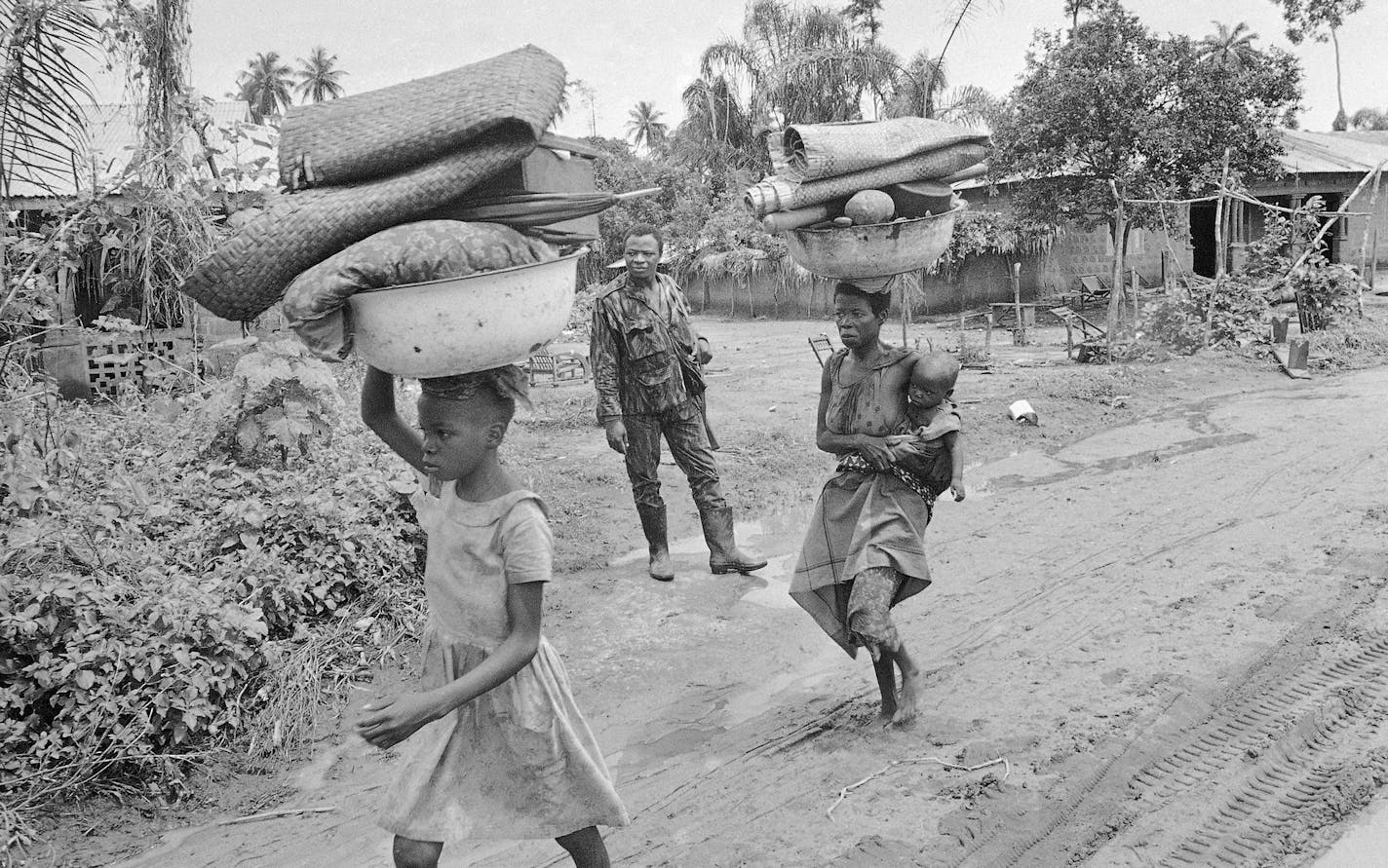 Refugees in the secessionist state of Biafra in Nigeria fled advancing federal troops near Owerri in September 1968 during the Nigerian Civil War.