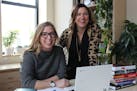 Loft Literary Center executive director Britt Udesen, left, and Steph Opitz work on plans for Wordplay.