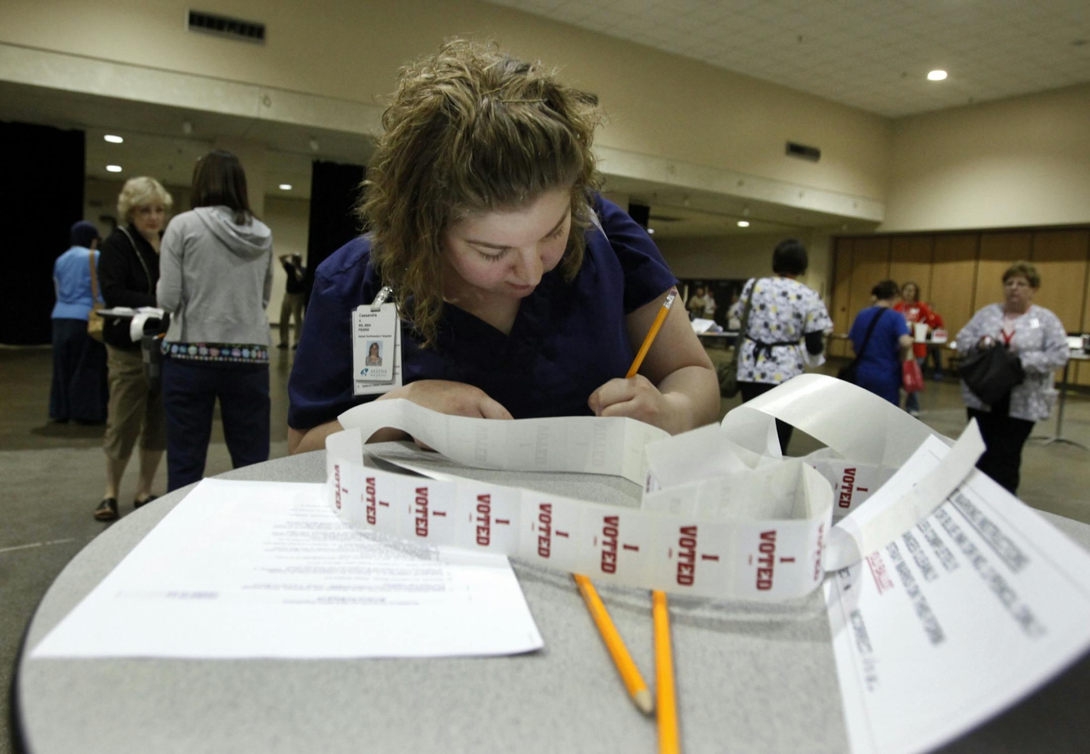 Cassie Vedders, a nurse at Abbott Northwestern Hospital, casts her ballot.