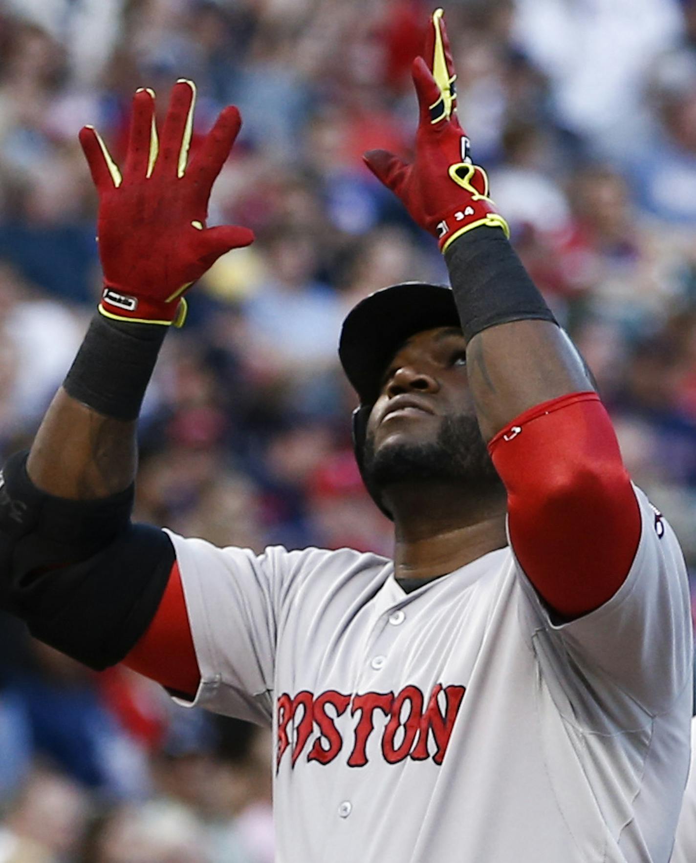 Boston Red Sox' David Ortiz, left, points to the sky after crossing home plate on his home run in front of Mike Napoli, right, after hitting a home run against the Texas Rangers during the third inning of a baseball game, Saturday, May 10, 2014, in Arlington, Texas. (AP Photo/Jim Cowsert)