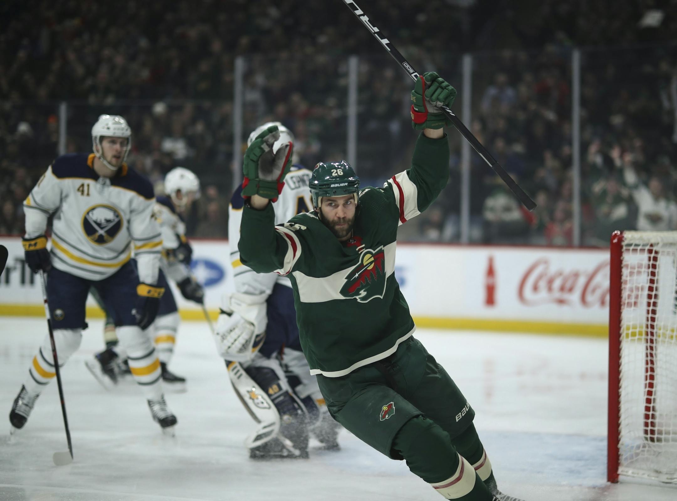 Minnesota left wing Daniel Winnik (26) celebrated after he scored the second Wild goal of the period on Sabres goaltender Robin Lehner (40).