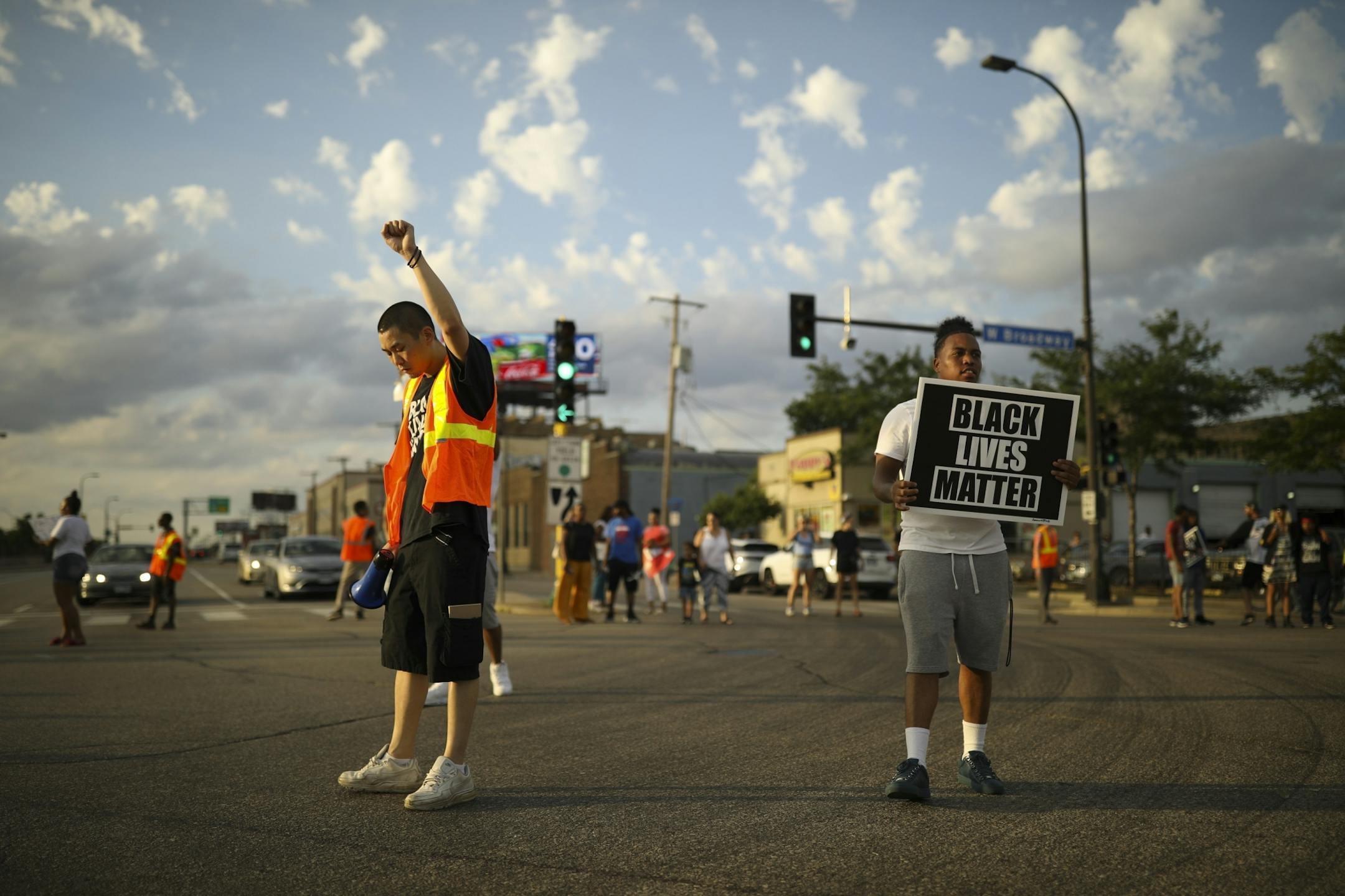 Peace walkers blocked the intersection of W. Broadway Ave. and Washington Ave. N. briefly before turning around and heading back west on W. Broadway Ave.