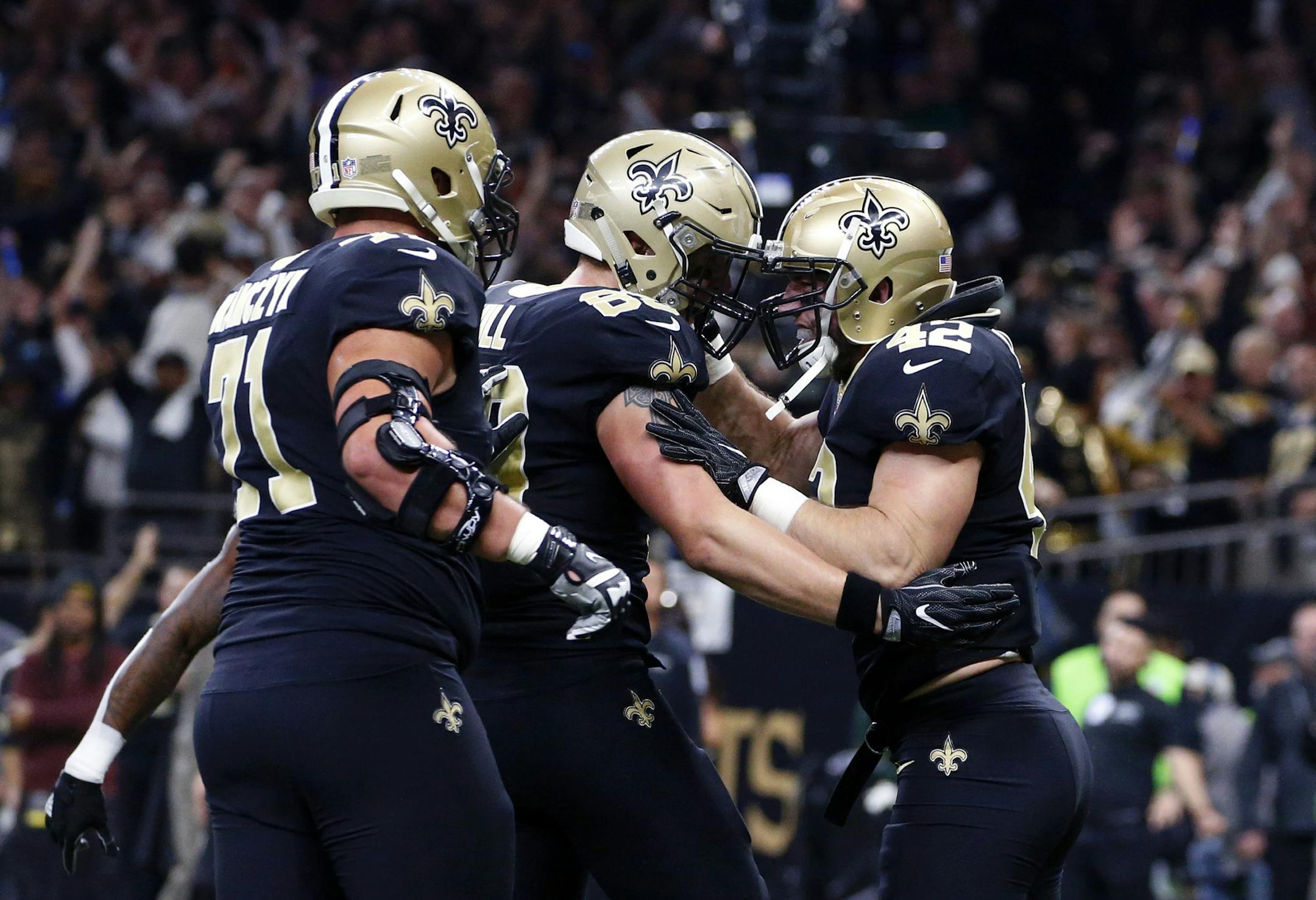 New Orleans Saints running back Zach Line (42) celebrates his touchdown with tight end Josh Hill (89) and offensive tackle Ryan Ramczyk (71) in the first half of an NFL football game against the Carolina Panthers in New Orleans, Sunday, Jan. 7, 2018. (AP Photo/Butch Dill)