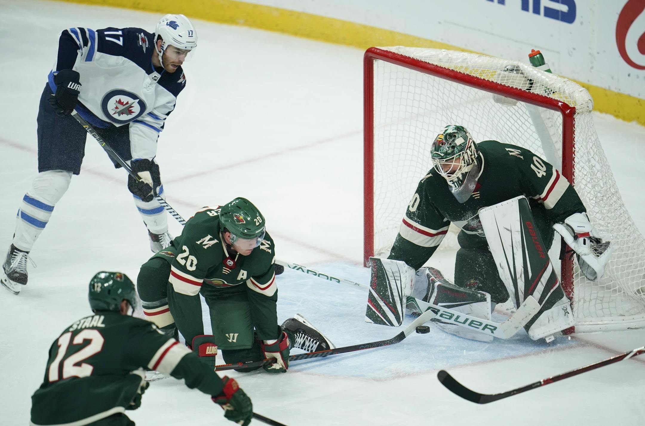 Minnesota Wild defenseman Ryan Suter (20) helped goaltender Devan Dubnyk stop an incoming Winnipeg shot in the third period.