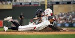 The Twins' Byron Buxton slides home just ahead of Tigers catcher Jake Rogers' tag, giving the Twins a 4-3 lead in the seventh inning of an eventual 5-