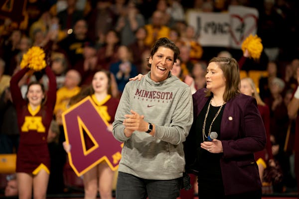Janel McCarville stood with Gophers coach and former teammate Lindsay Whalen during Sunday's jersey retirement ceremony