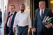 Defendant Said Shafii Farah, center, walks into the U.S. District Court with his attorneys Clayton Carlson, left, and Steve Schleicher during the Feed