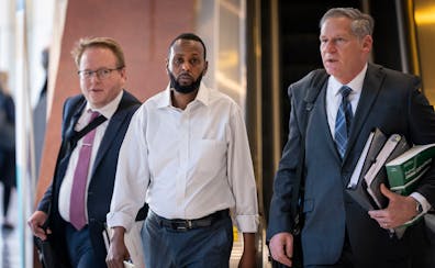Defendant Said Shafii Farah, center, walks into the U.S. District Court with his attorneys Clayton Carlson, left, and Steve Schleicher, right, during 