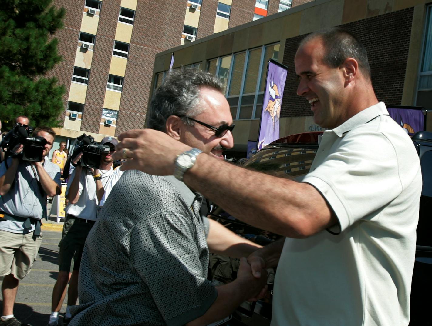 Jerry Holt/Star Tribune Mankato MN 7/29/2005----Minnesota Vikings new owner Zygi Wilf left shakes hands with Viking head coach Mike Tice as the his teams arrives Friday at Minnesota State University in Mankato.