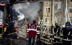 Emergency workers clear the rubble on the site of a destroyed building after a Russian attack on residential neighborhood in Odesa, Ukraine, Saturday,