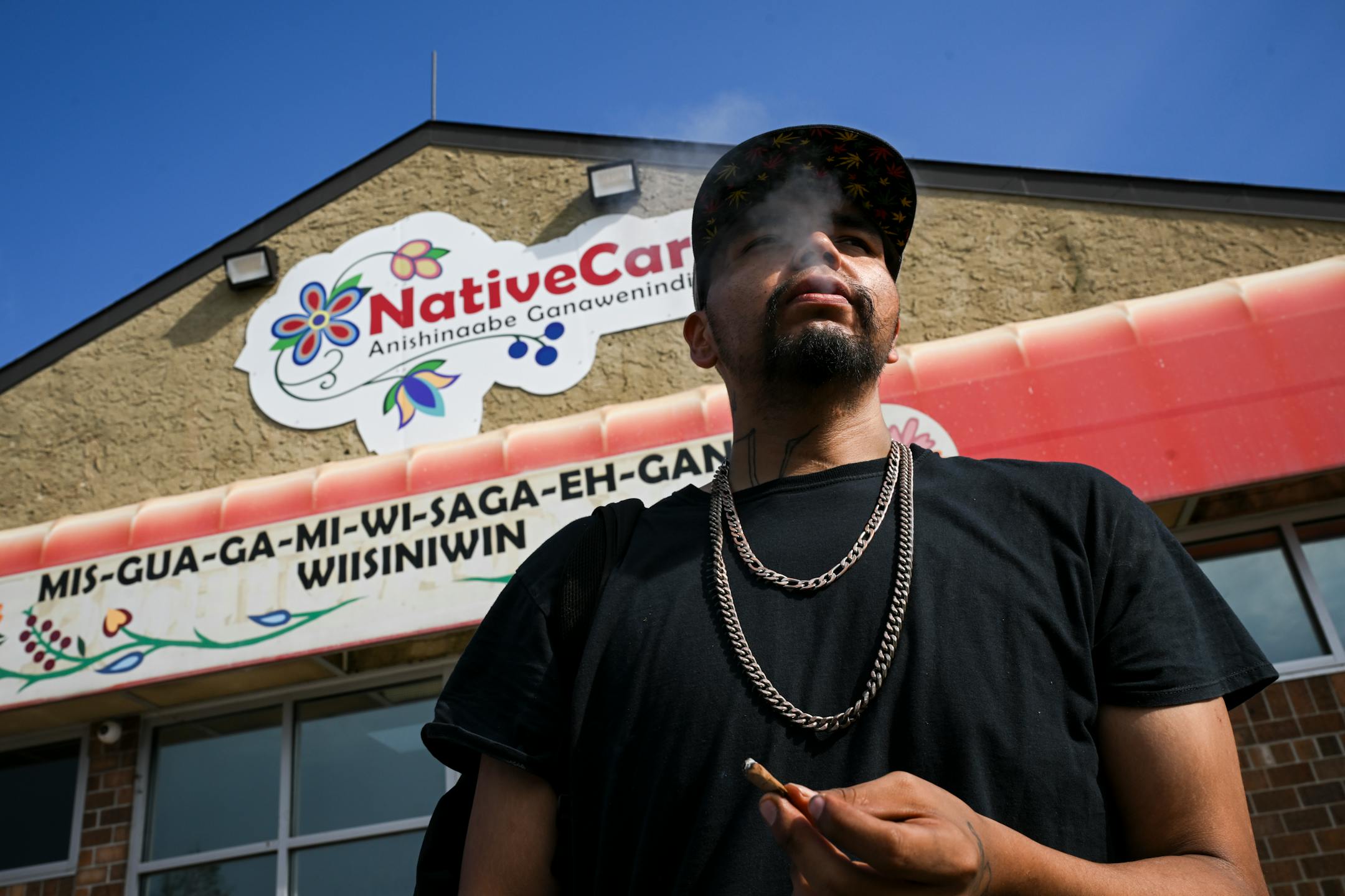 Eugene Sayers, of Red Lake, smokes a blunt and a joint while waiting for the dispensary's opening Tuesday, Aug. 1, 2023 at NativeCare in Red Lake, Minn.