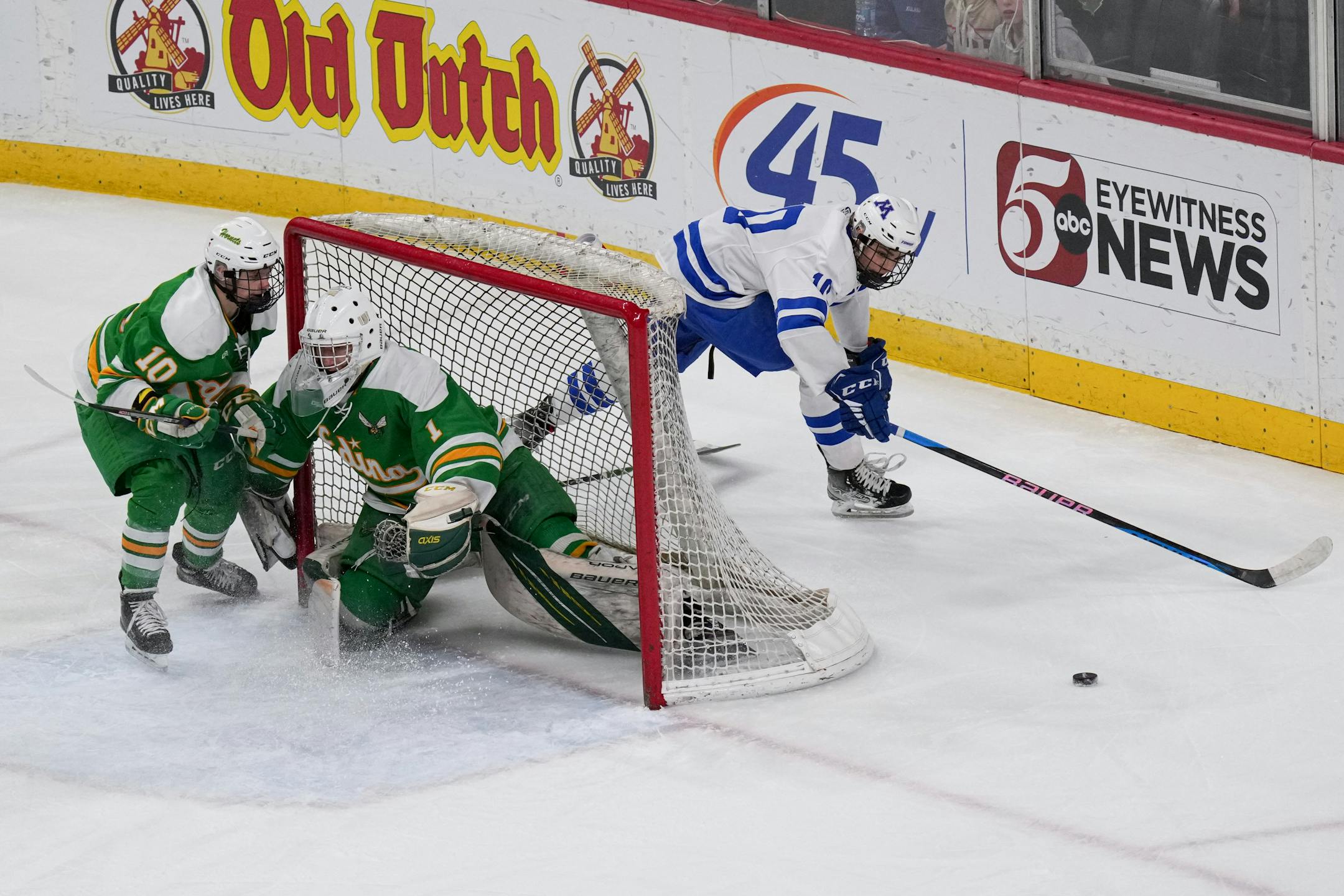 Minnetonka forward Luke Garry (10) tries to move the puck around the Edina net in the second period.