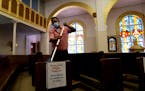 Juan Arriola helps clean and sanitize pews following an in-person Mass at Christ the King Catholic Church in San Antonio, Tuesday, May 19, 2020. San A