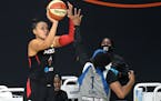 Las Vegas guard Kayla McBride goes up to shoot in front of Lynx guard Odyssey Sims