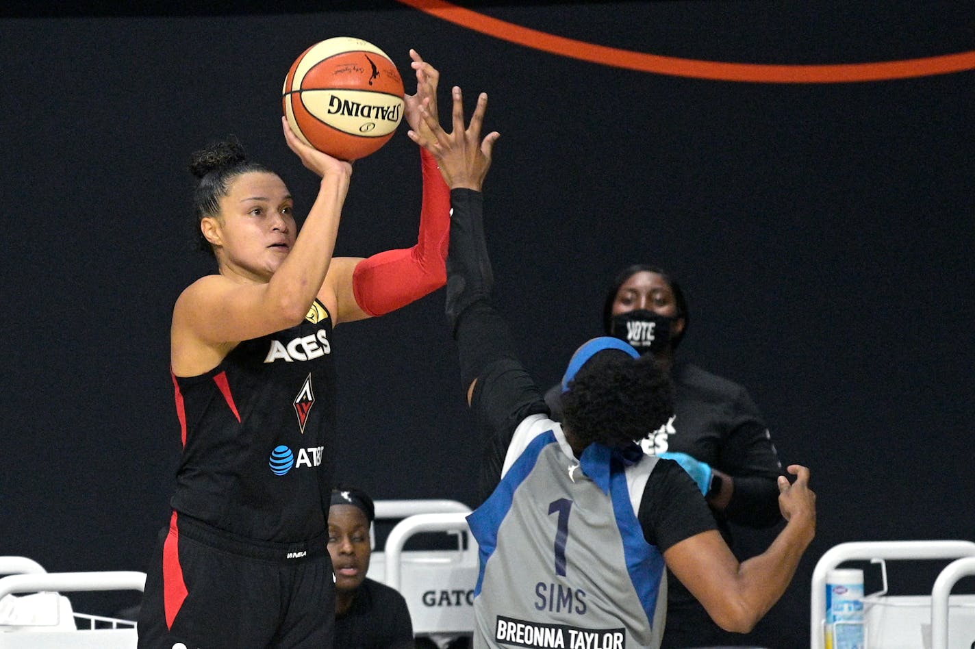 Las Vegas guard Kayla McBride goes up to shoot in front of Lynx guard Odyssey Sims