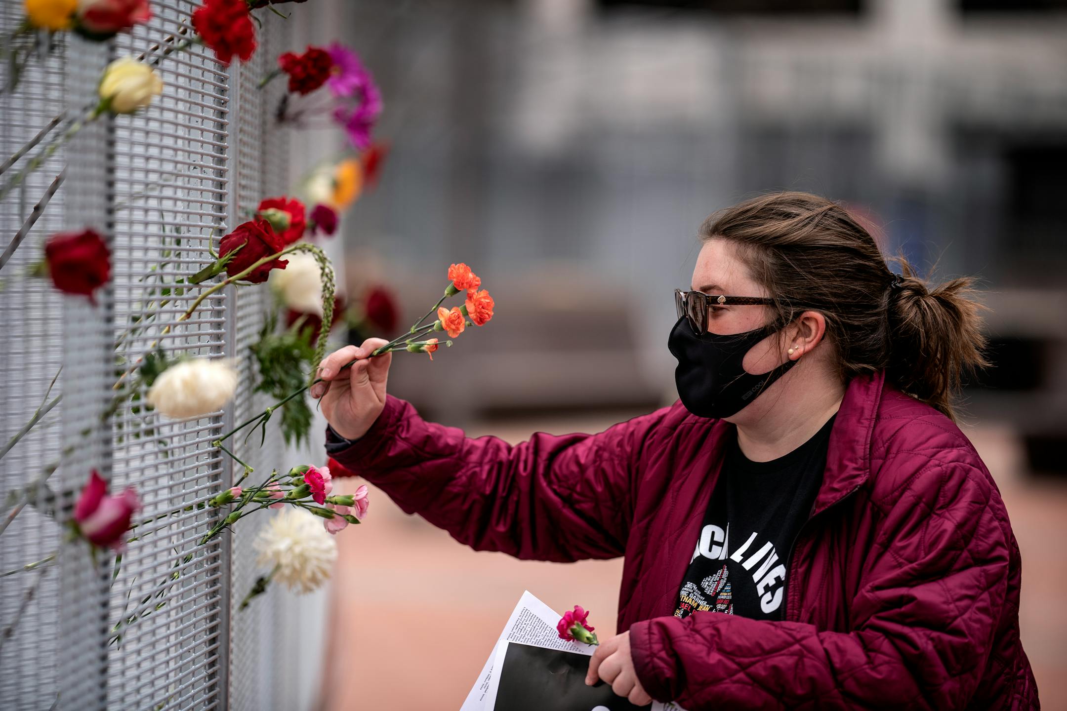 Flowers were placed on the fence in front of the Hennepin County Government Center by Stacey Bornholdt one day before jury selection is set to begin in the trial of former Minneapolis officer Derek Chauvin.