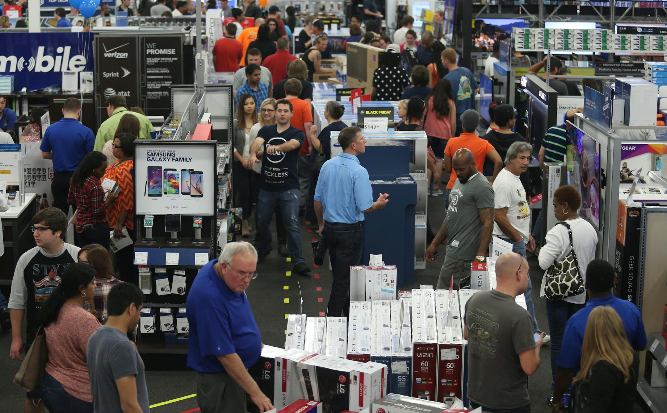 People look at merchandise while holiday shopping at Best Buy on Thursday, Nov. 26, 2015, in Panama City, Fla. Early numbers arenÌt out yet on how many shoppers headed to stores on Thanksgiving, but itÌs expected that more than three times the number of people will venture out to shop on the day after the holiday known as Black Friday. (Patti Blake/News Herald via AP) MANDATORY CREDIT ORG XMIT: MIN2015121812543936