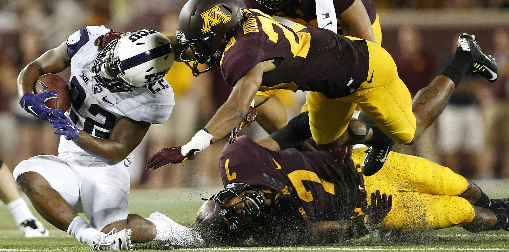 Aaron Green (22) of TCU was tackled by Briean Boddy Calhoun (29) and Damarius Travis (7) in the third quarter. ] CARLOS GONZALEZ cgonzalez@startribune.com - September 3, 2015, Minneapolis, MN, TCF Bank Stadium, NCAA Football, Big 10, University of Minnesota Golden Gophers vs. Texas Christian University TCU Horned Frogs ORG XMIT: MIN1509032322522463