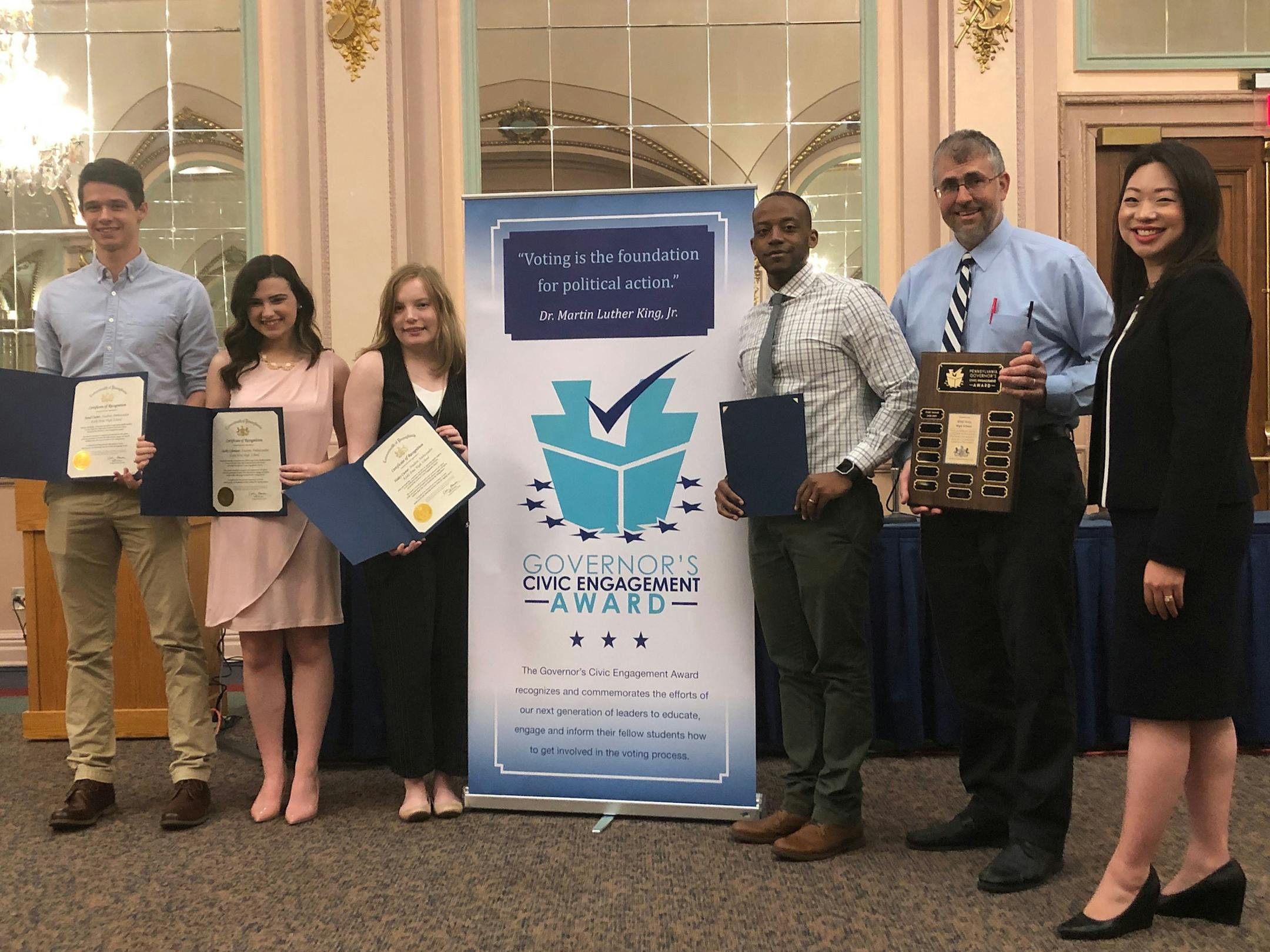 From left, Kiski Area High School students Jared Custer, 18; Shelby Glentzer, 18; Haley Custer, 18; Kiski Area High School teachers David Williamson and Jim McKensie; and Tiffany Chang Lawson, Director of the Bureau of Campaign Finance and Civic Engagement at Pennsylvania Department of State. Lawson presented the group with a Governor's Civic Engagement Gold Award at a recognition program at the University of Pittsburgh on Tuesday, May 7. The award recognizes high schools where at least 85% of e