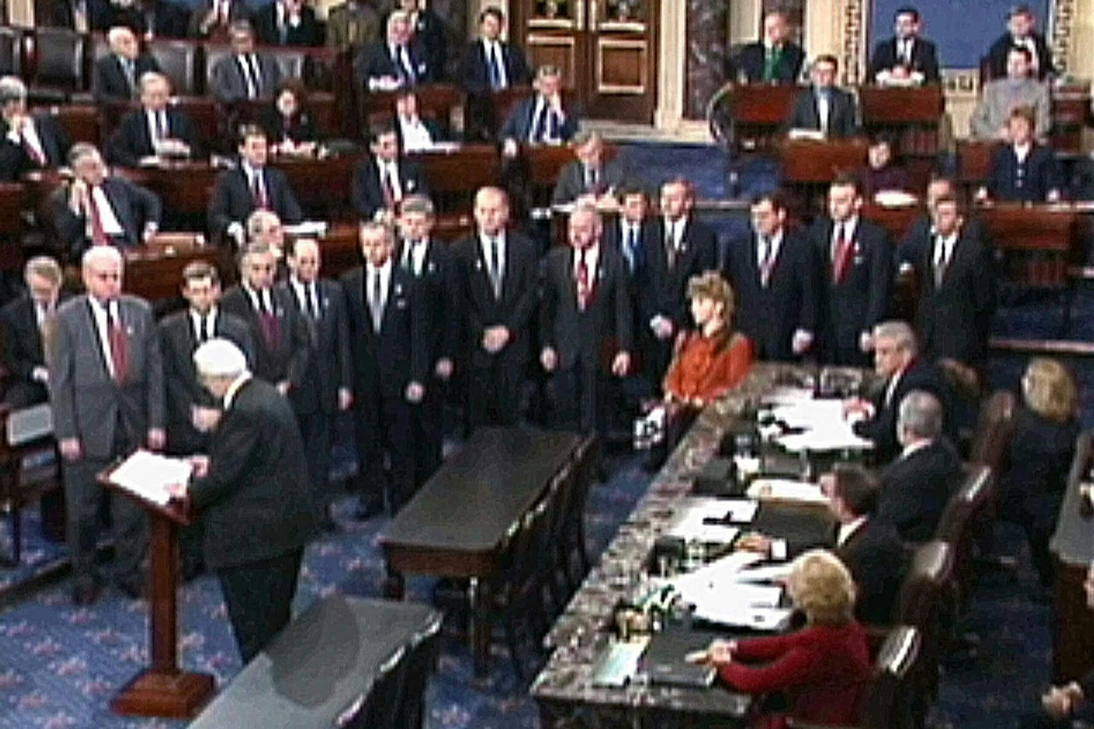 FILE - In this Jan. 7, 1999, image from video, House Judiciary Committee Chairman Rep. Henry Hyde, R-Ill., reads the articles of impeachment against President Bill Clinton to the Senate as the other House managers who will conduct the impeachment trial watch in Washington. As House Democrats quickly move forward with impeachment proceedings against President Donald Trump, much remains unknown about how a Senate trial would a proceed, including what the charges would be. (AP Photo/APTN) ORG XMIT: