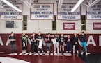 The Augsburg women's wrestling team practices daily at 7 a.m. in a gym adorned with the championship banners of the men's team.