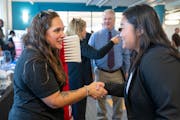 Rosa Larson from Delta Dental shakes hands with Pae Say, a job seeker, during the third annual Veterans & Community Job Fair on Wednesday, September 2