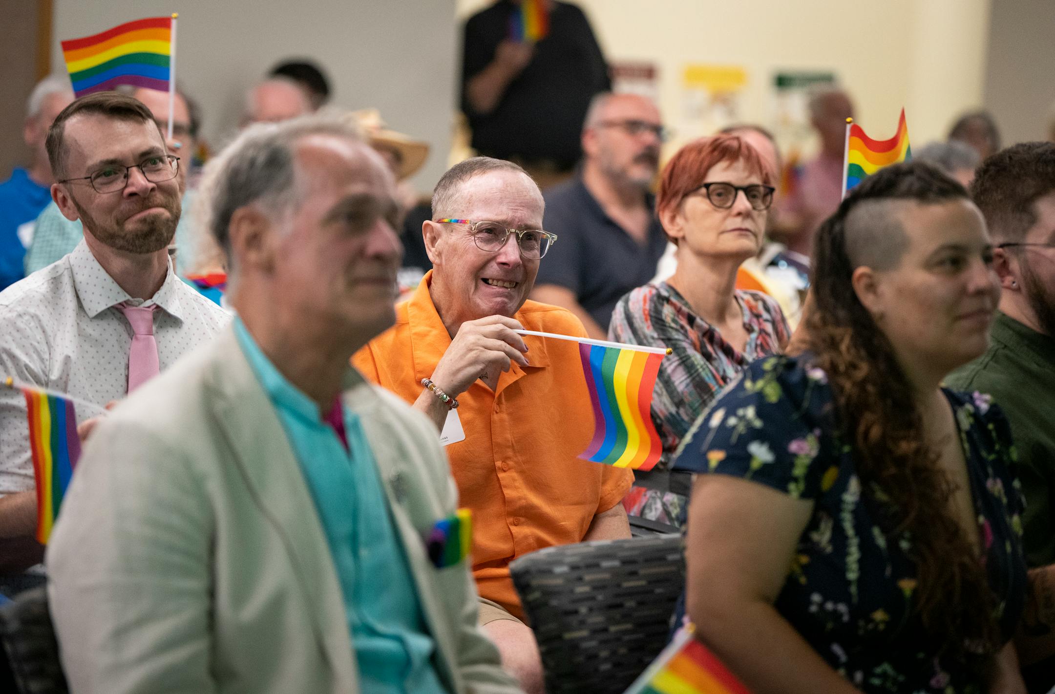 Rick Simon, a friend and former colleague of Tretter's, got emotional as they all sang "Somewhere Over the Rainbow" while waving rainbow flags to end the celebration of life for Jean-Nickolaus Tretter at the Elmer L. Andersen Library on the campus of the University of Minnesota on Friday, June 23, 2023 in Minneapolis. Tretter, who passed away in 2022, was the founder and namesake of the Tretter Collection in GLBT Studies at the University of Minnesota Libraries, Archives and Special Collections.
