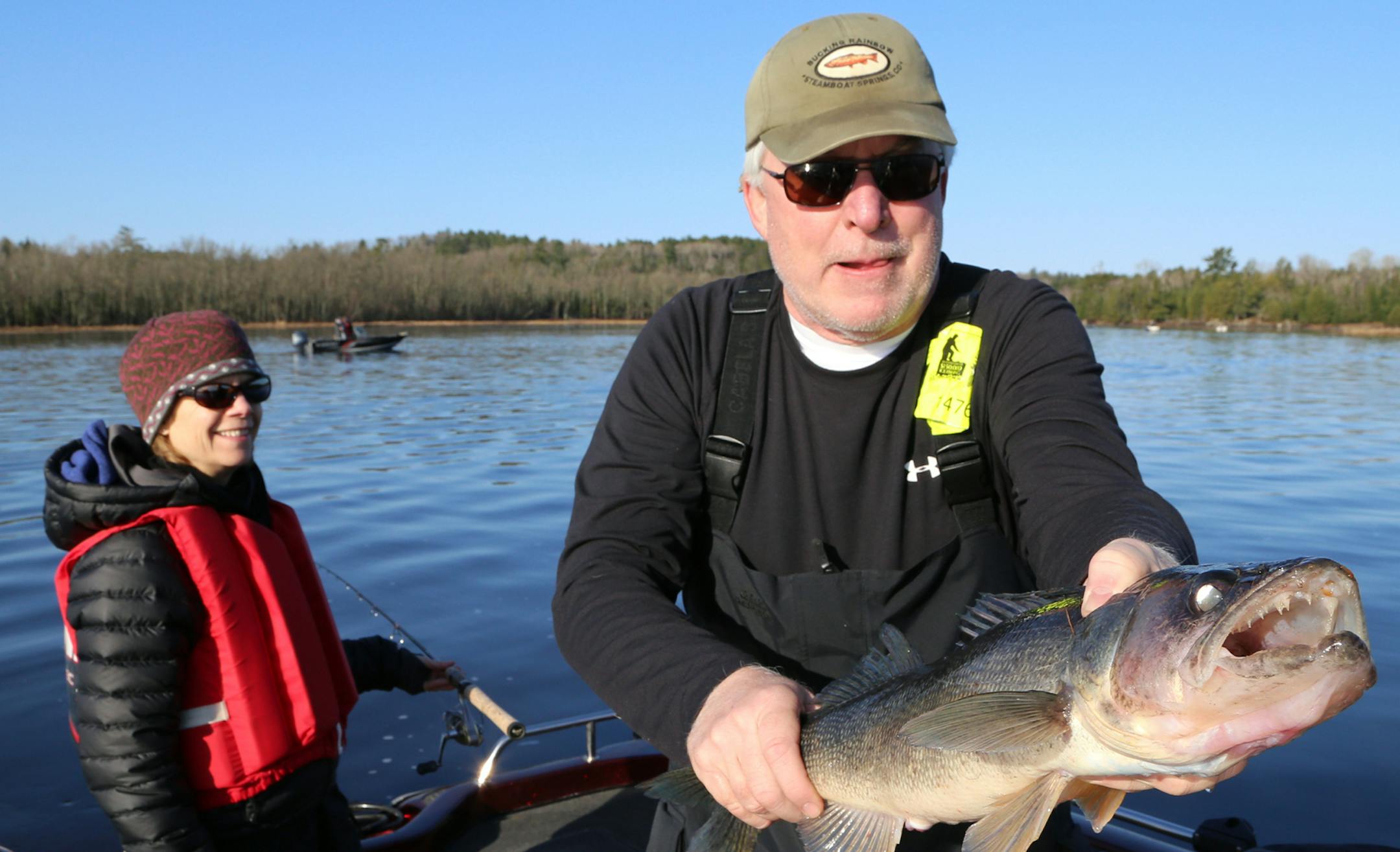 Tom Ellsworth of Excelsior holds a monster walleye boated on Crane Lake, while his wife, Nancy, looks on. Fishing on the border lake was pretty good Saturday, and the weather was better.