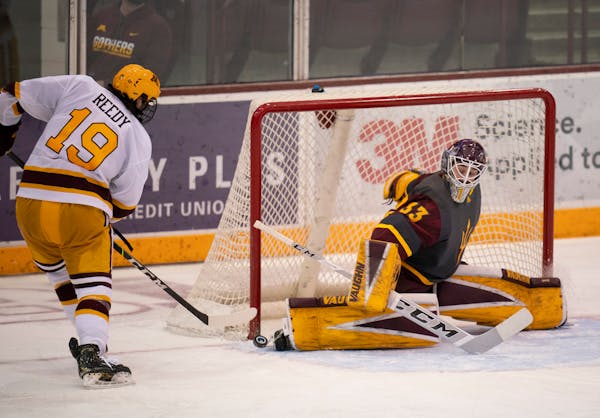 Sun Devils goalie Bronson Moore just barely got a skate on a third period shot by Minnesota Gophers right wing Scott Reedy (19). ] JEFF WHEELER • je
