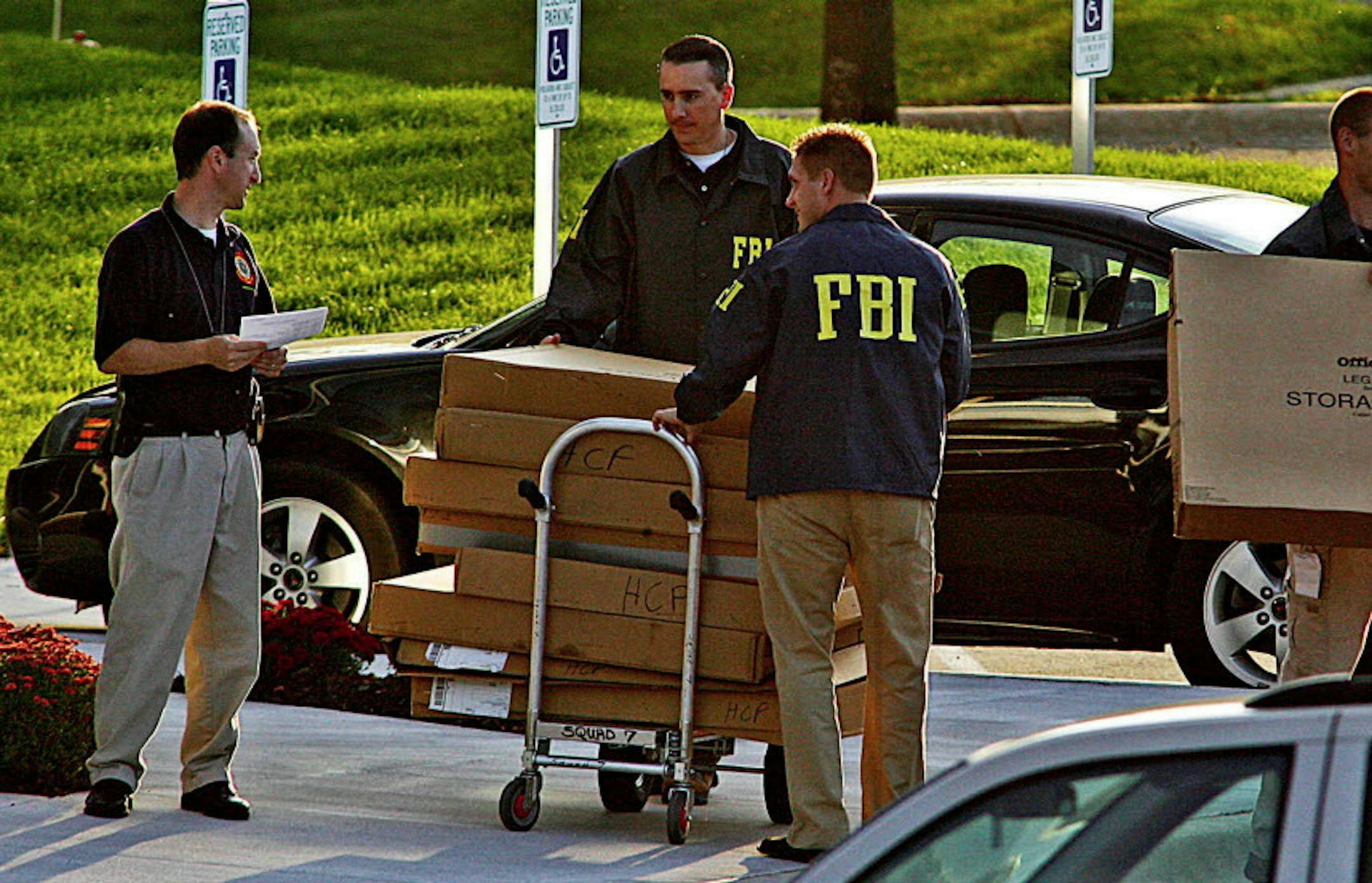 ** ADVANCE FOR MONDAY OCT. 26 ** **FILE** In this Sept. 24, 2008 file photo, FBI agents haul boxes of unknown items from the Petters Group headquarters building in Minnetonka, Minn. Tom Petters, whose Petters Group Worldwide had stakes in companies including Polaroid and Sun Country Airlines, goes on trial beginning Oct. 26 accused of orchestrating a multibillion dollar Ponzi scheme. (AP Photo/The Star Tribune, Marlin Levison, file)**ST. PAUL OUT, NO MAGS, NO SALES, NO TV**