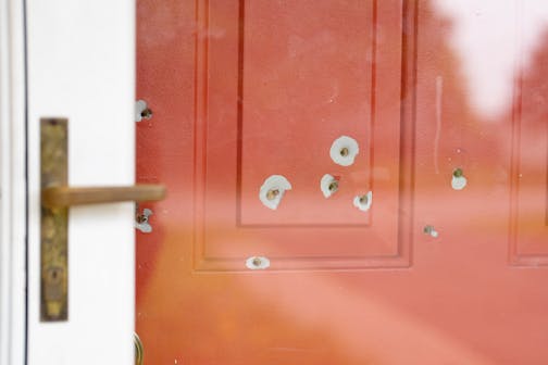 Bullet holes in the front door of Minnesota State Sen. John Hoffman’s home are visible in Champlin, Minn. on June 16.